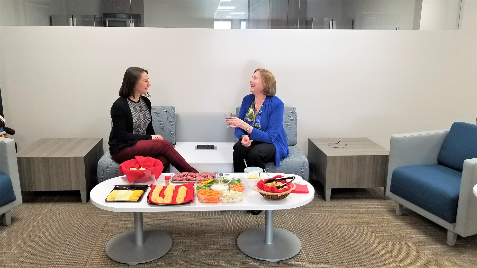 Dawn Benchelt and Anna Kuta enjoy the new IMC updated community space. Renovations were completed to the team’s space early this year, featuring a new kitchen, open-floor plan, new collaboration rooms, and a new conference room. 