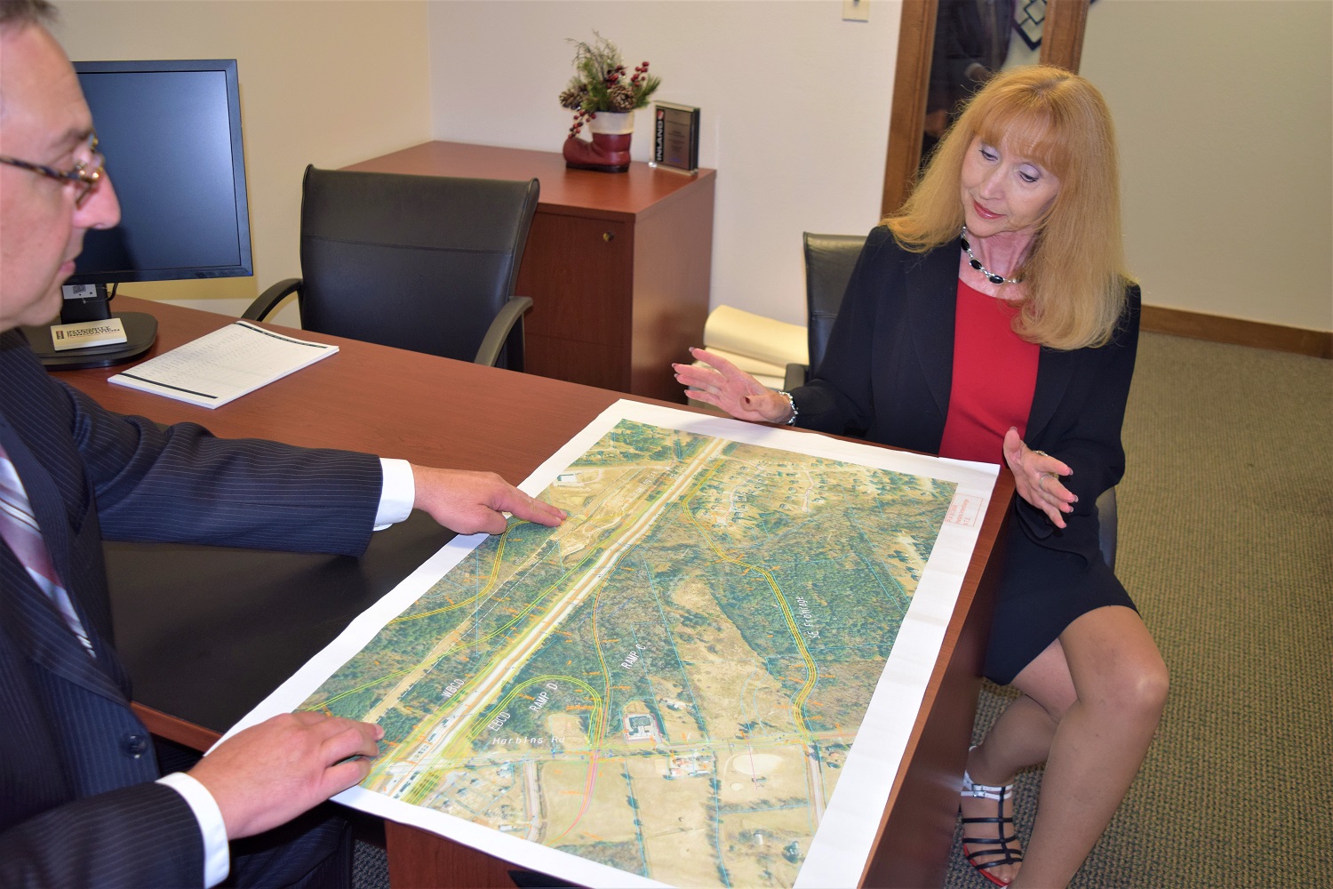 Kathy Corke and Scott Filippelli review a map of a property in IMC’s portfolio. 